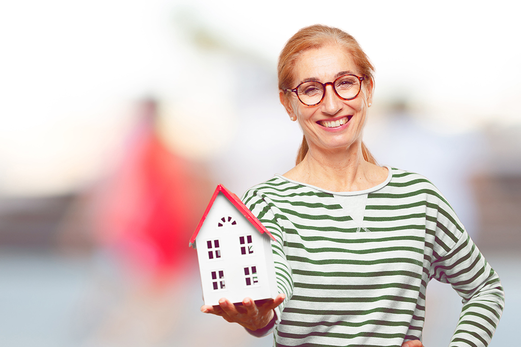 Happy Woman holding a House minature